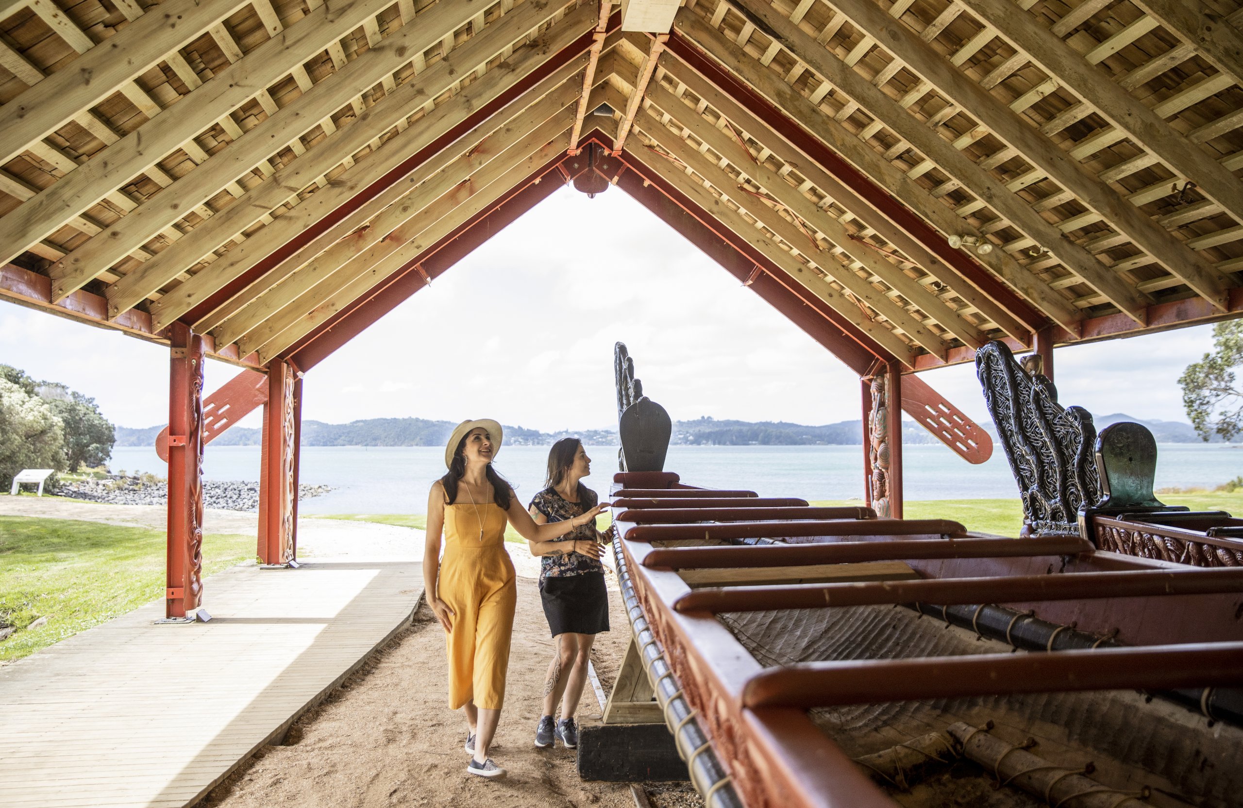 Visitors looking at Ngātokimatawhaorua at Waitangi