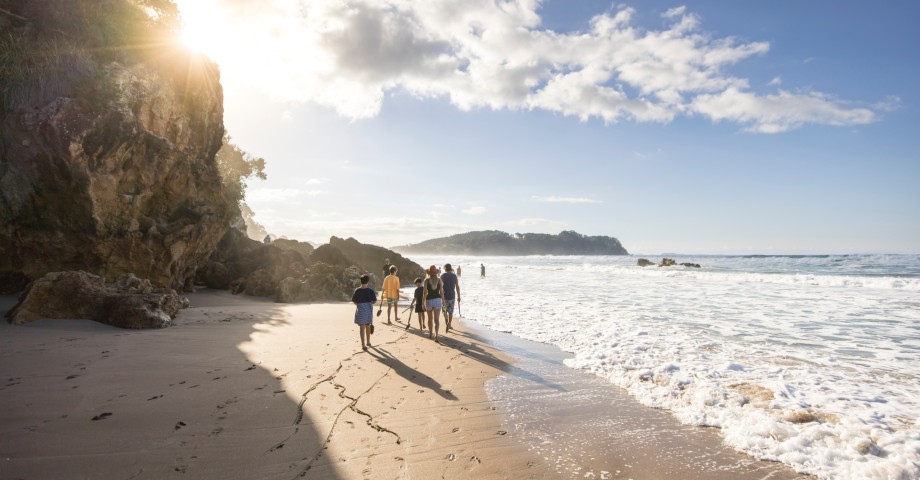 Group of people walking along Hot Water Beach